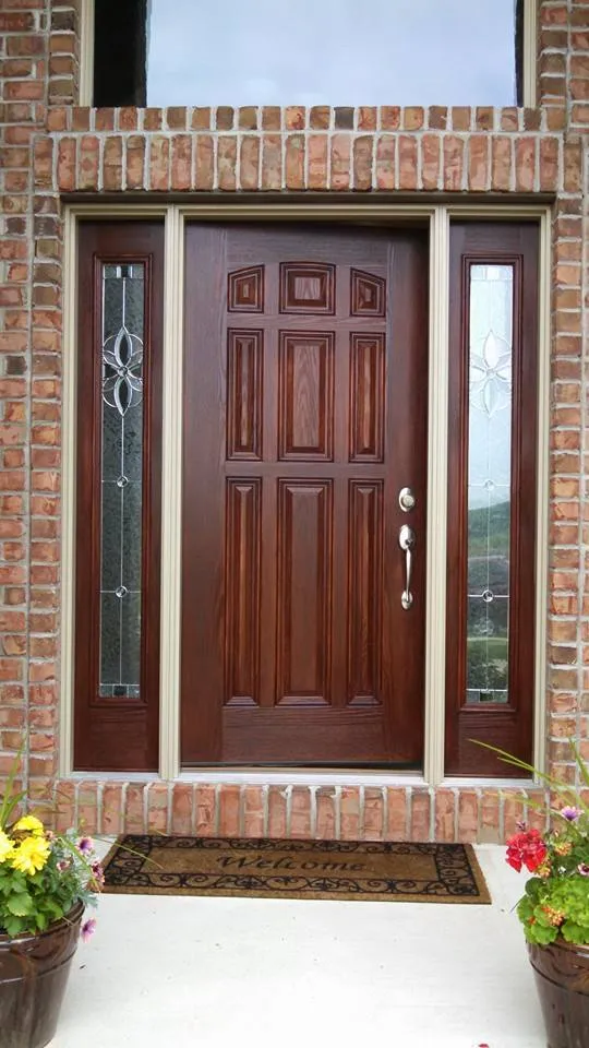 The same front door refinished in a deep reddish-brown stain with a clear, even finish